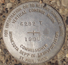 Survey marker where Marshall Avenue intersects John Ireland Boulevard.