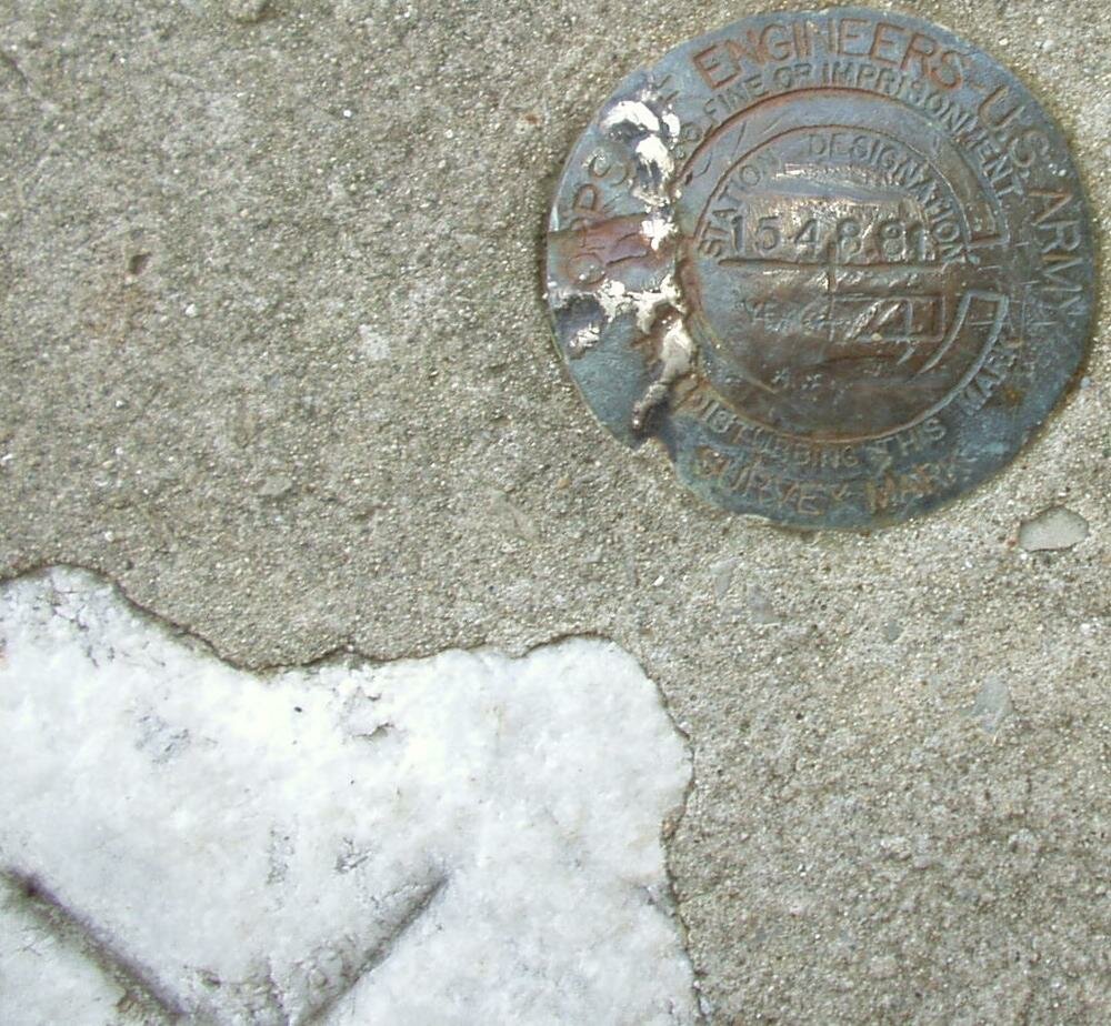 Marker and white stone with X